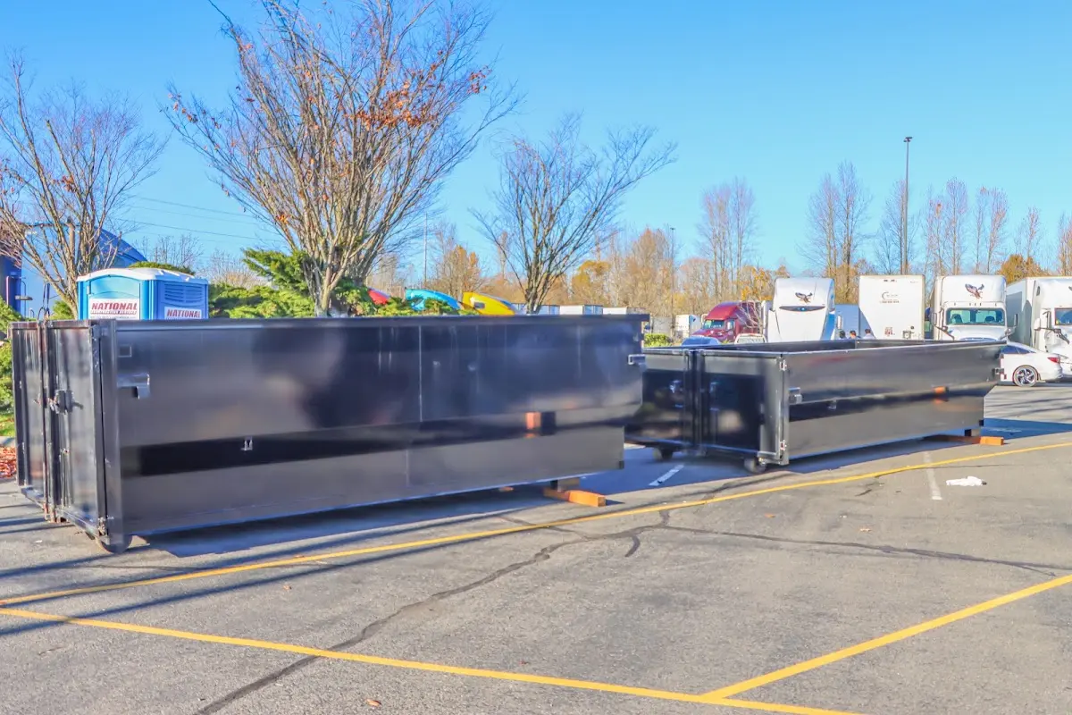 Professional dumpster rental service with roll-off container on residential driveway in Pueblo